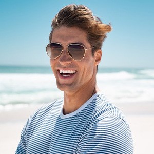 Man smiling while on the beach
