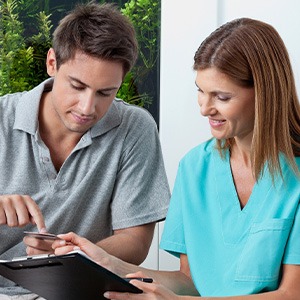 Patient and staff member discussing payment