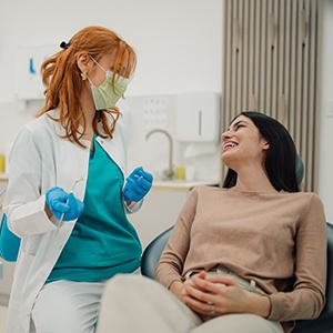 Smiling patient and dentist talking in treatment room