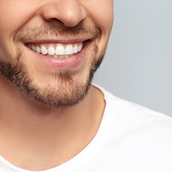 Man in white t-shirt smiling