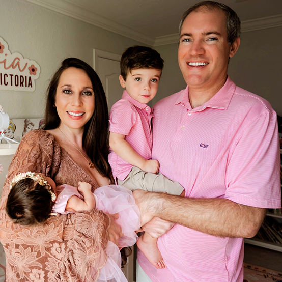 Doctor Rodriguez with his wife and young son with trees in background