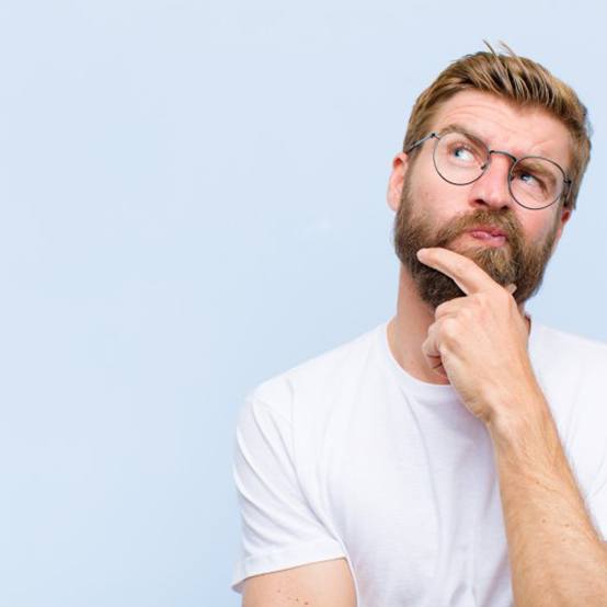 Man tapping his chin in a questioning pose