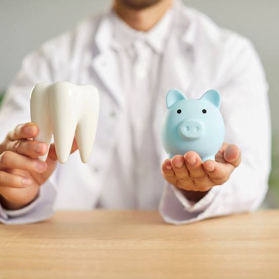 Man in dental chair smiling at reflection in mirror with dentist blurry in background