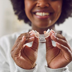 Patient holding a take-home whitening tray