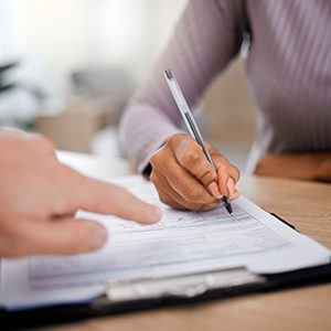 a woman signing patient forms