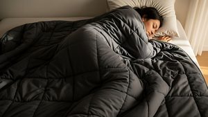 Woman in bed sleeping under weighted blanket